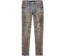 Skinny-Jeans mit Farbklecksen