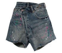 paint-splatter asymmetric denim shorts