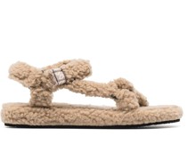 Flache Sandalen aus Faux Shearling