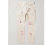 Schmal geschnittene Jeans mit Lederapplikationen in Distressed-Optik