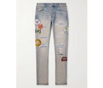 Schmal geschnittene Jeans mit Applikationen in Distressed-Optik