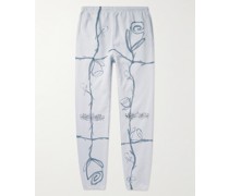 Schmal geschnittene und schmaler zulaufende Jogginghose aus Baumwoll-Jersey mit Kristallen und Print